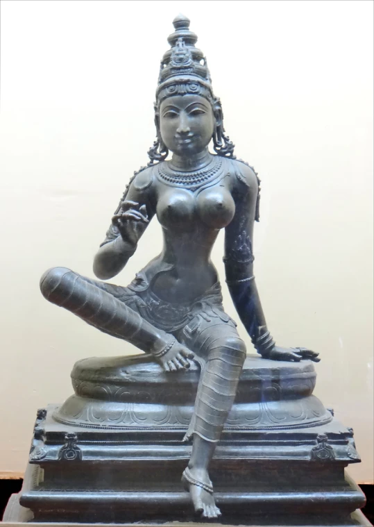 a statue is displayed in glass and metal