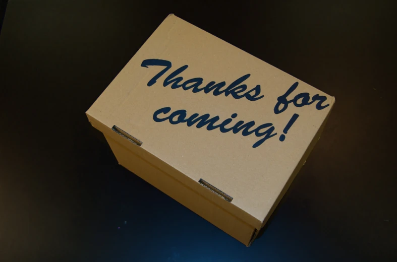 a box that says thanks for coming on the table