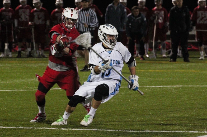 two people on the field with a lacrosse ball