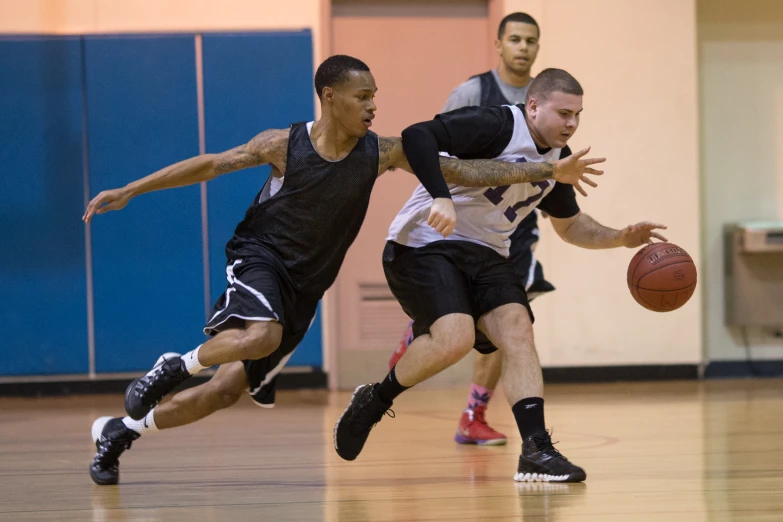 there are two men playing basketball on a court