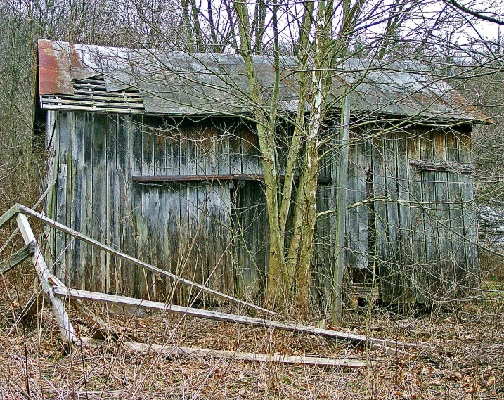 a building behind a fence with two wooden poles