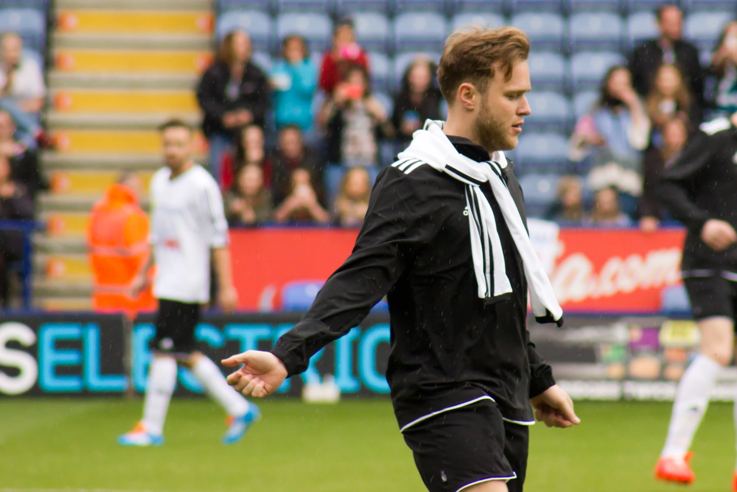 a soccer player in a stadium wearing black and white