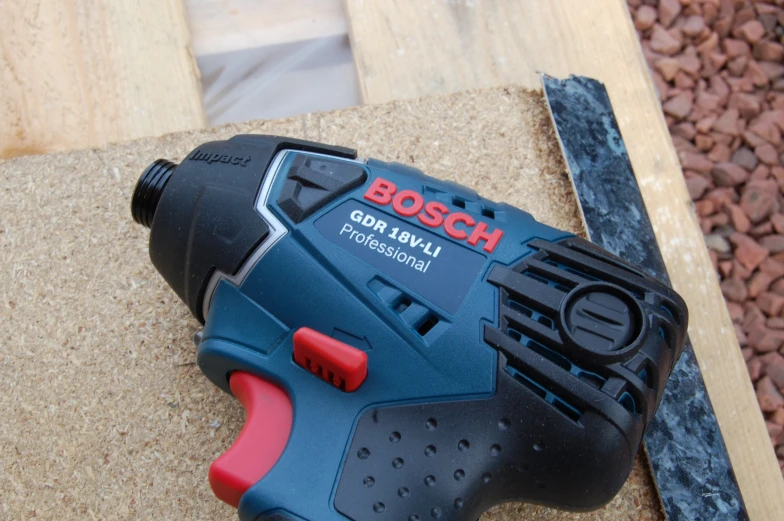 a bosch tool on a table with it's cover showing