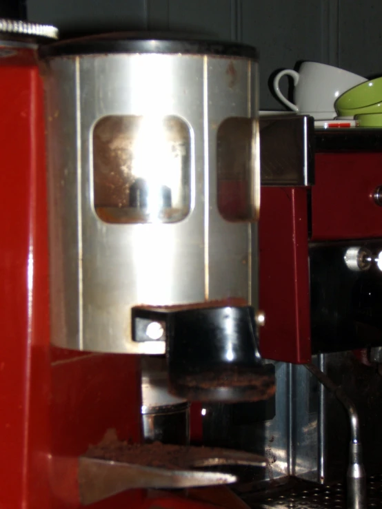 a red machine on top of a metal counter