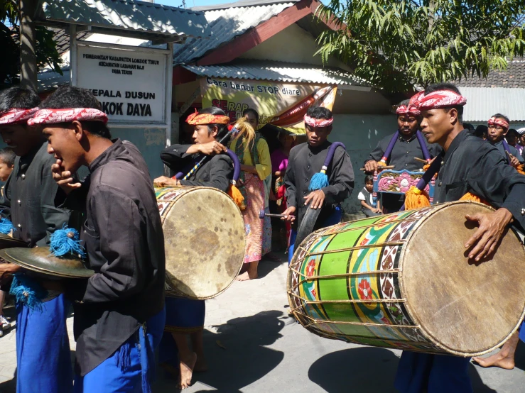 some people are carrying musical instruments in the street