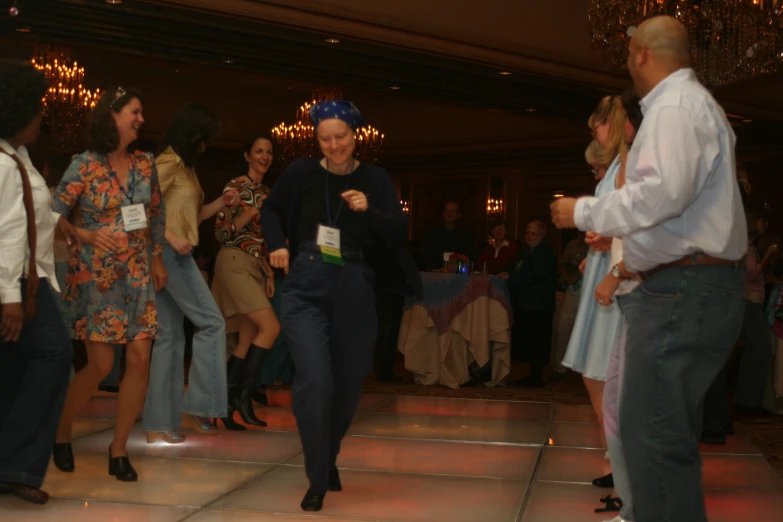 a man standing next to a women on a dance floor