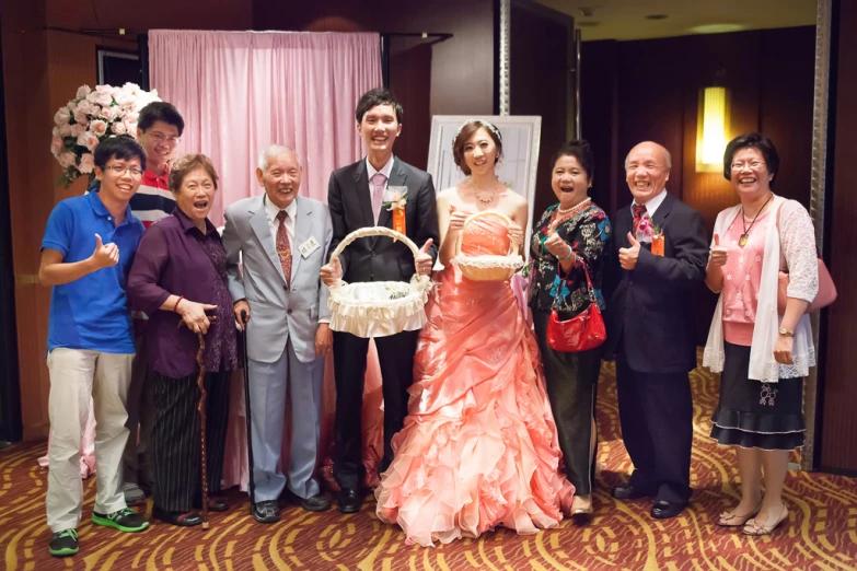 group of people posing in formal dress in room