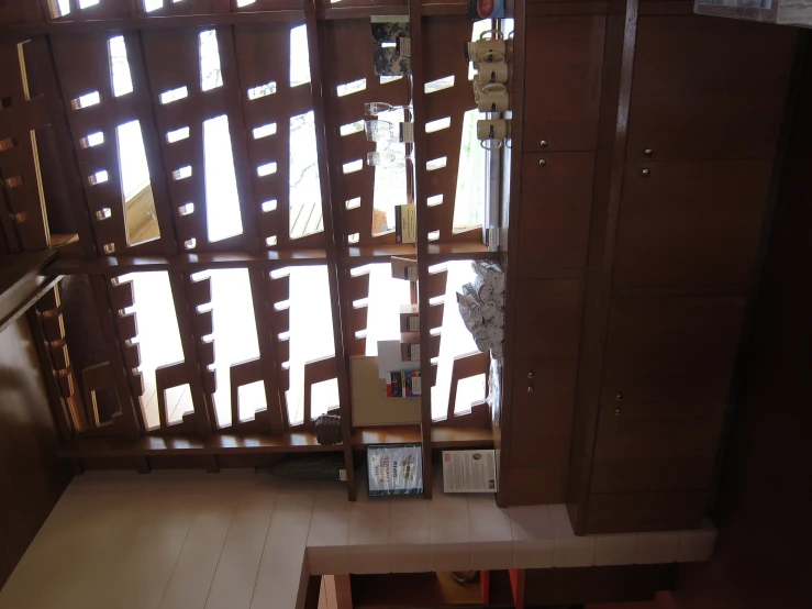 a kitchen counter with light streaming in through the blinds