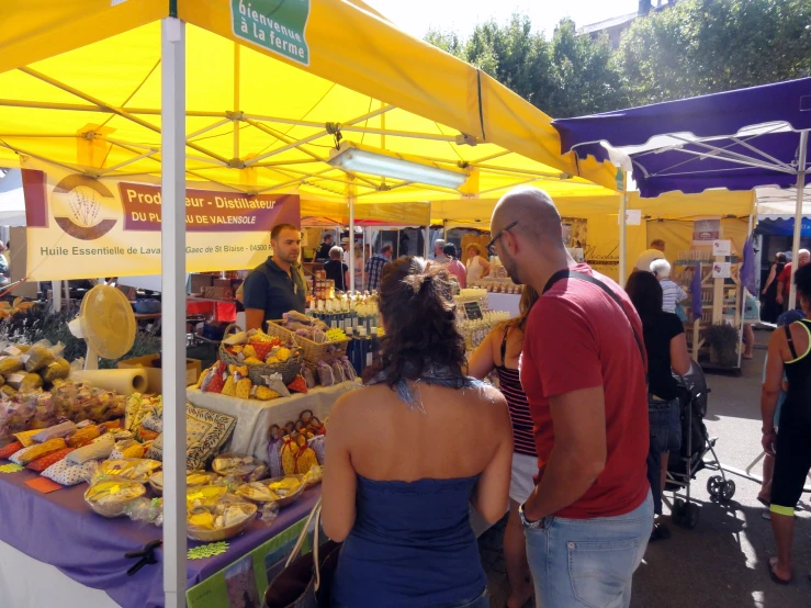 people standing around at an open air market