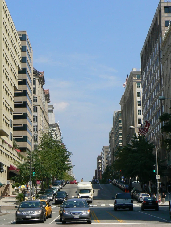 a view of several vehicles moving down a city street