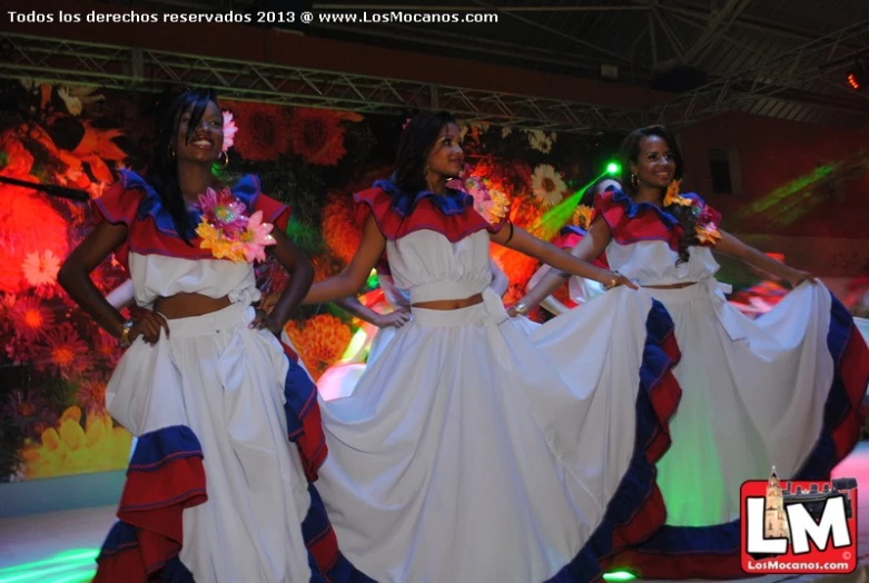 four female performers in bright colors performing on stage