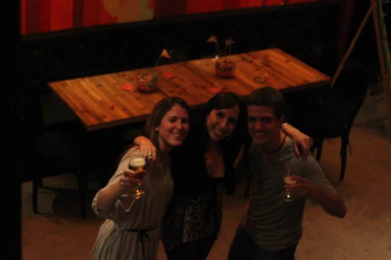 a group of friends are standing at a table