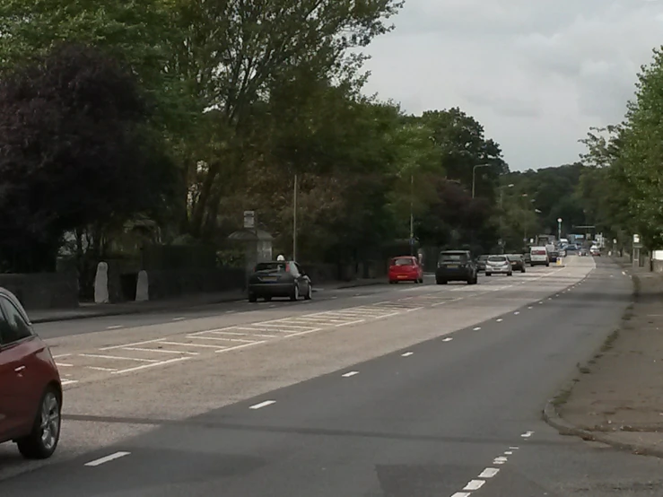 cars driving down an empty city road