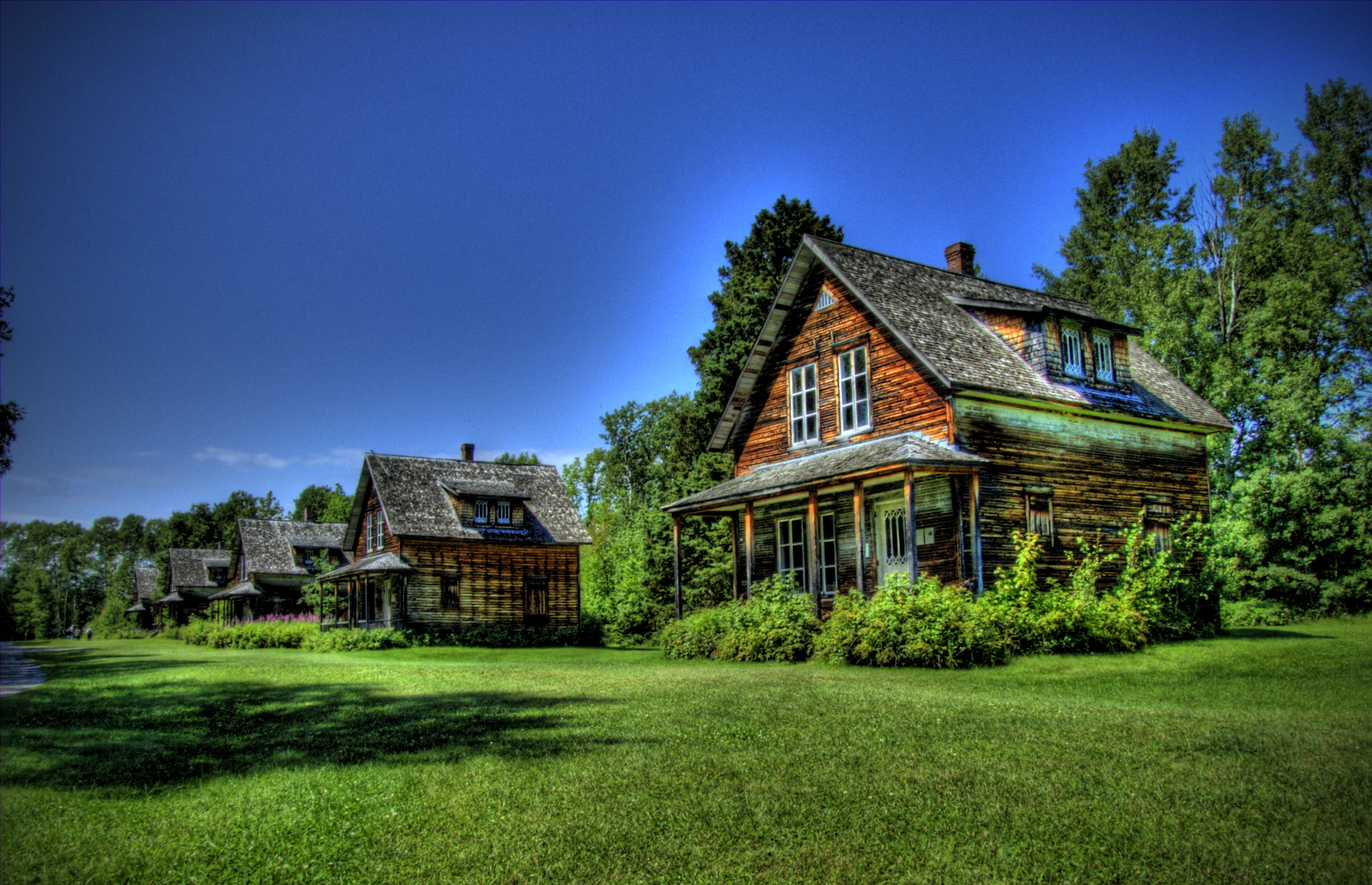 an image of an old fashioned house in the woods