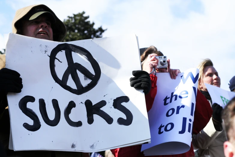 there are many people holding signs in a protest