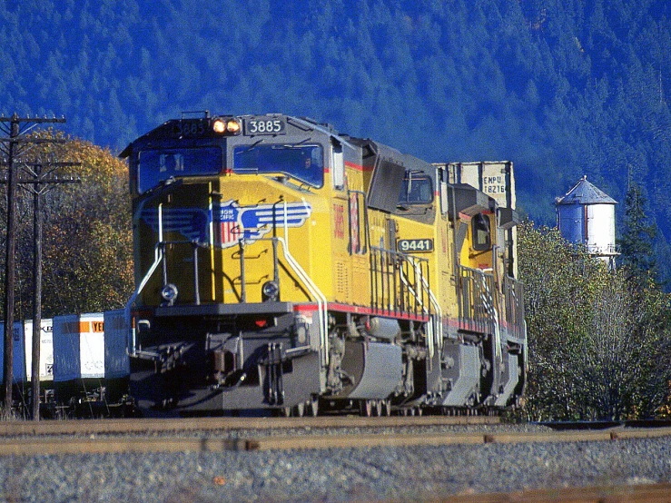 a train engine carrying carts down train tracks