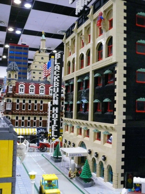 a toy town set up in a store filled with large buildings and lots of windows