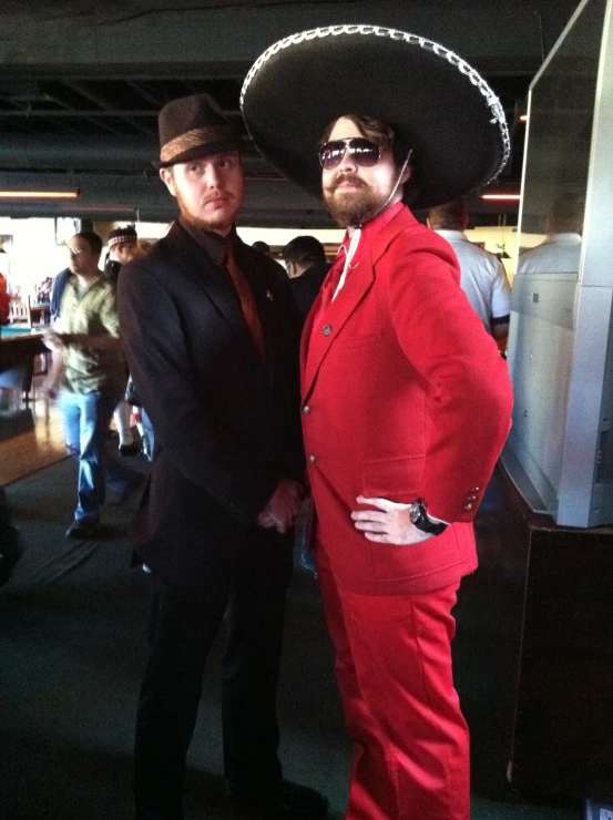 two guys in suits and hats pose for a po