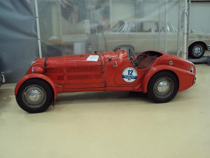 a small old model of a car with no wheels