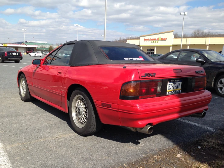 a red sports car in the parking lot