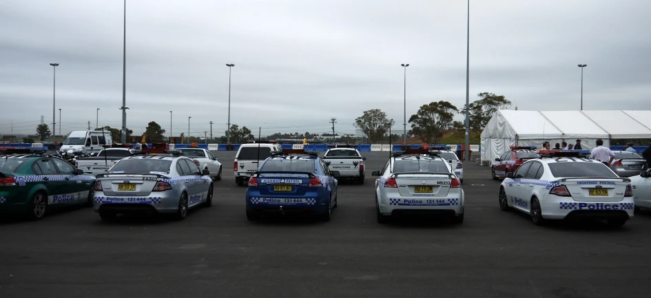 five police cars parked in a parking lot next to each other