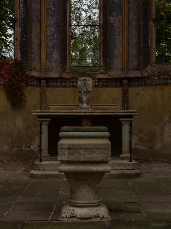 a stone statue in the middle of an empty room