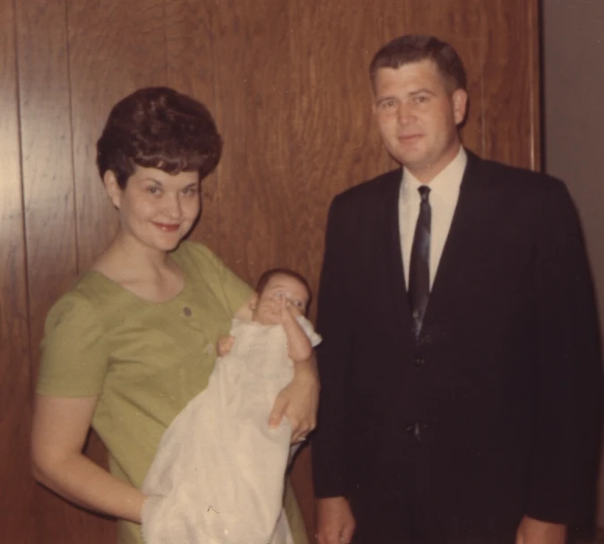 a man and woman in formal clothing pose for a picture