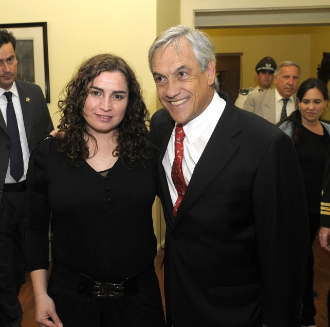 two people wearing suits and ties pose for a picture