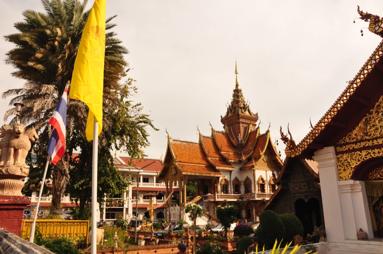 some people are standing near several ornate buildings