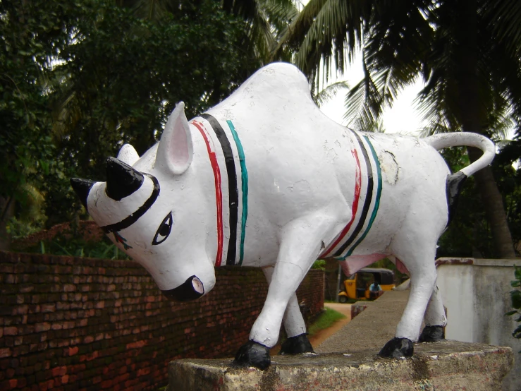 a statue of an ox is on a brick wall