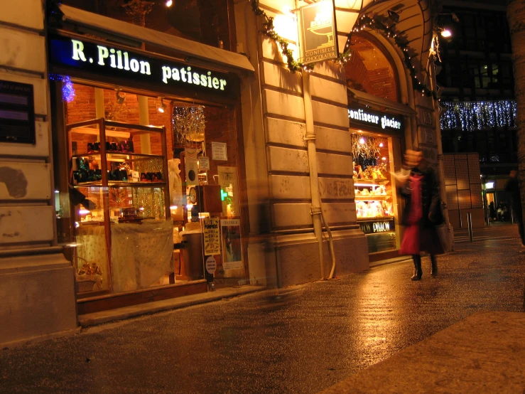 the facade of a pharmacy shop lit up at night