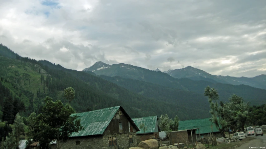 there is a house in the middle of the mountains