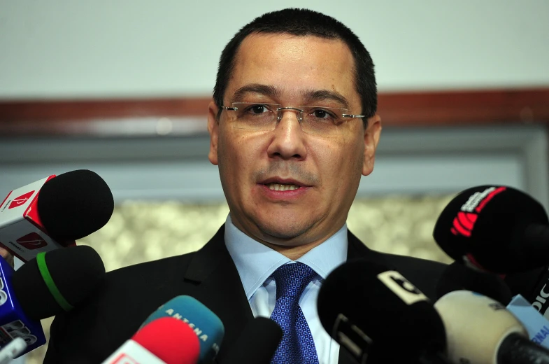 a man standing in front of microphones and microphones