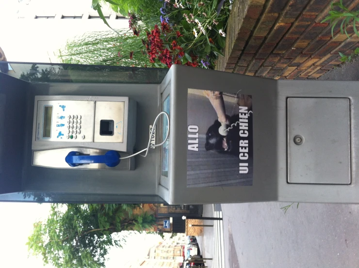 an image of a telephone and newspaper machine