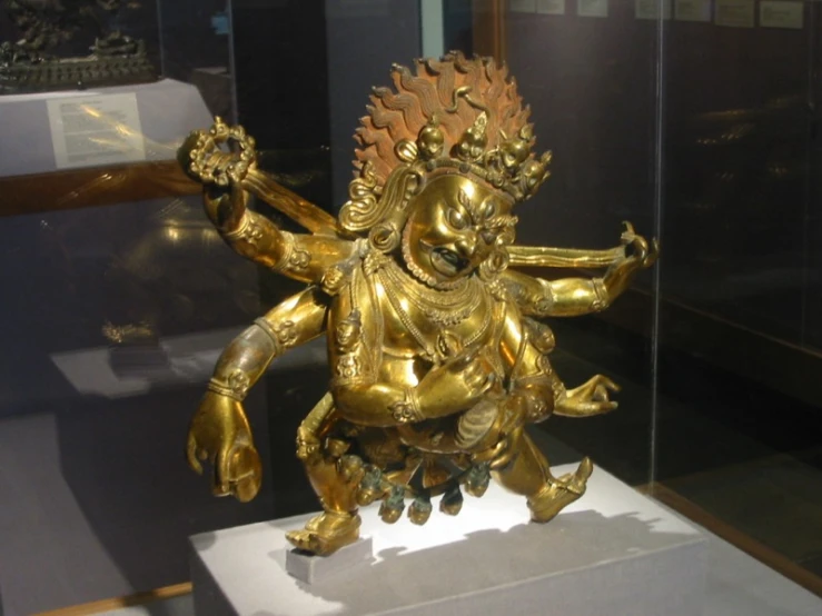 gold figurine in front of glass display case
