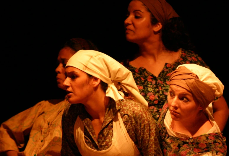 a group of women with headscarves looking off to the side