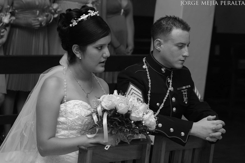 a bride and groom look at the wedding bouquet