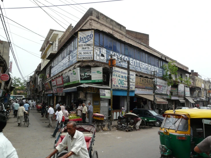 a busy street lined with small, colorful shops and people