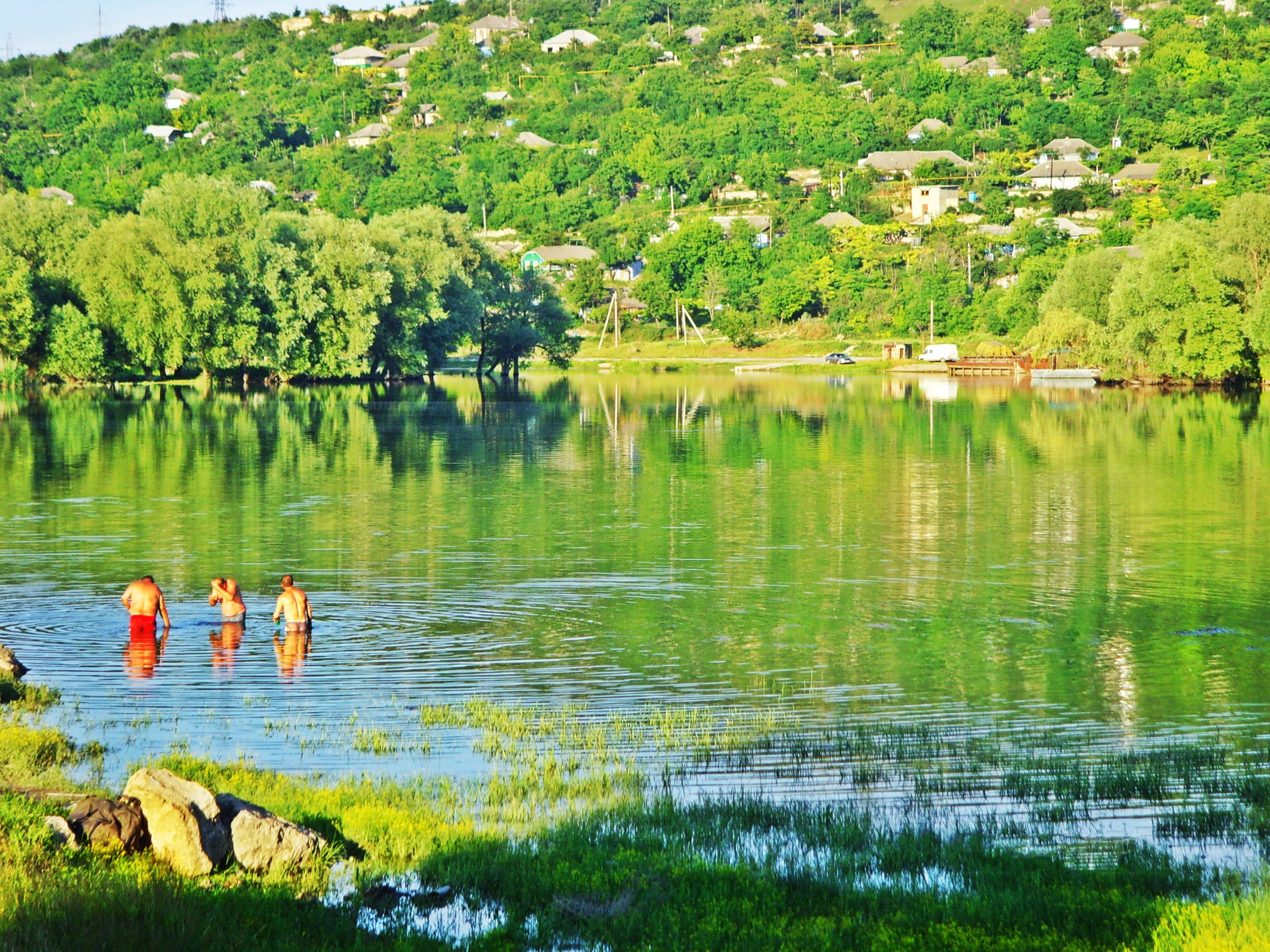 people on horses are standing in the water