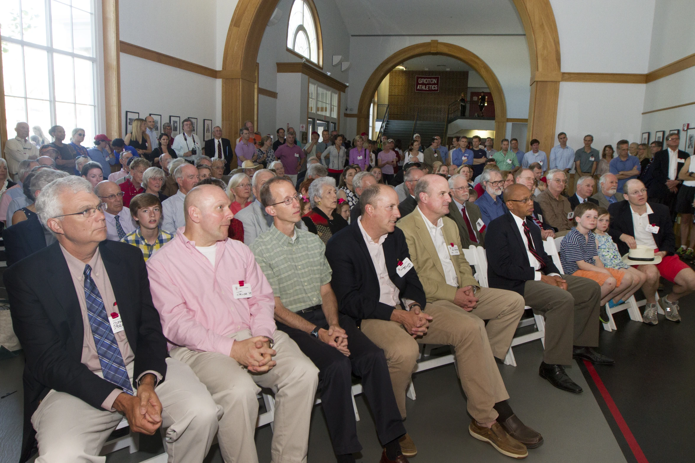 many people sitting down in chairs in front of the crowd