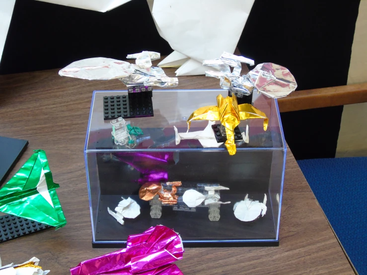 a box on a desk filled with colorful items