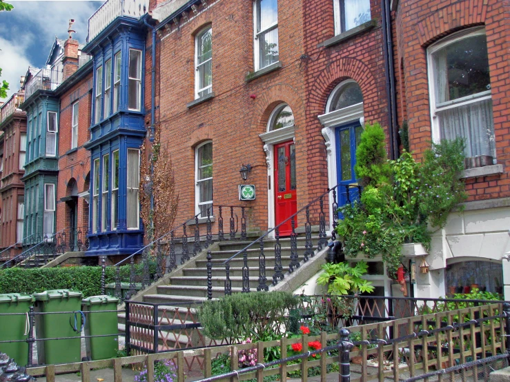 brick houses with balconies and trees in the front