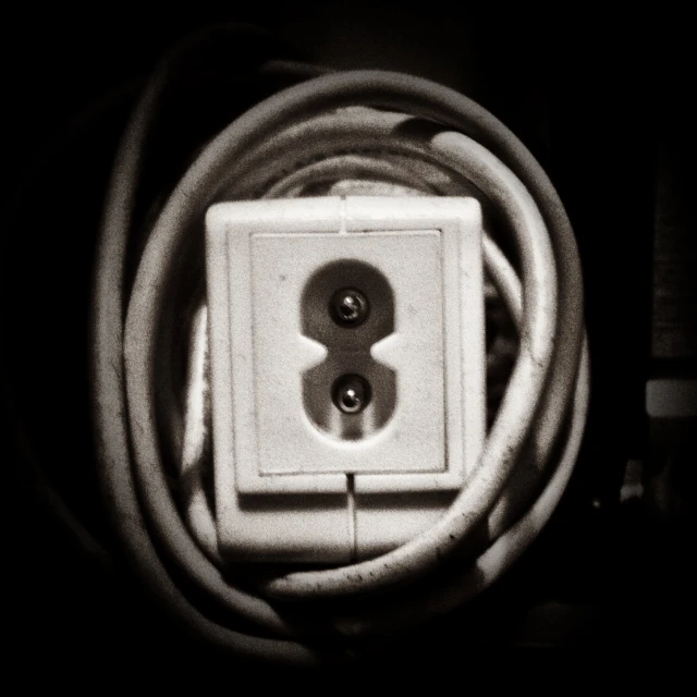 a square box with the center light on sitting in a corded socket