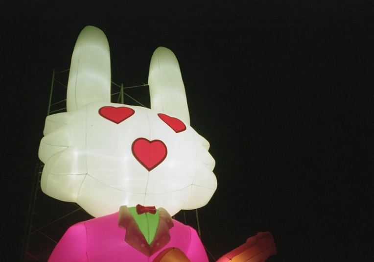 a white paper rabbit with red hearts in his head