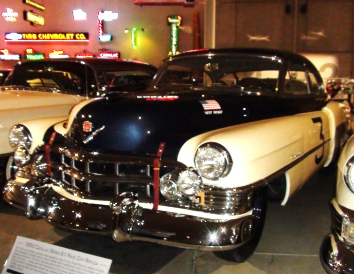 several different types of vintage cars parked on display