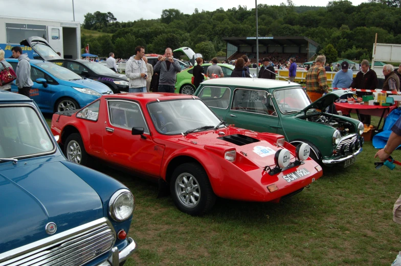 several small cars are parked together in a row