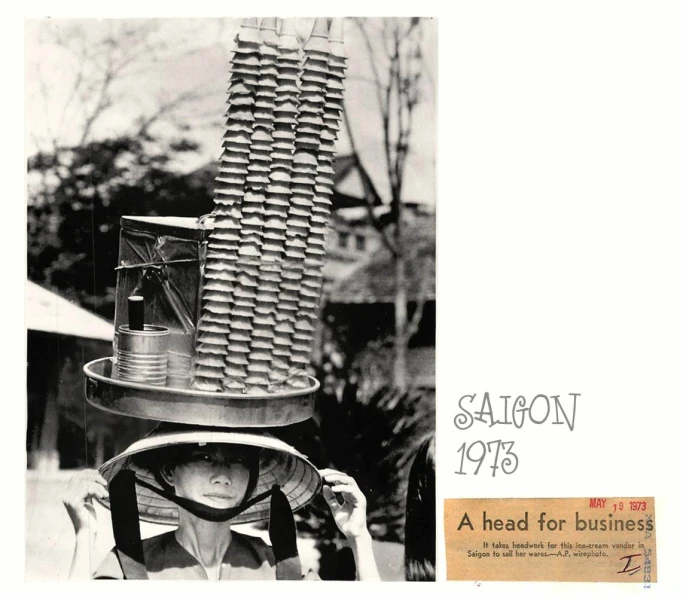 vintage po of woman holding a hat with hair combs stacked on top