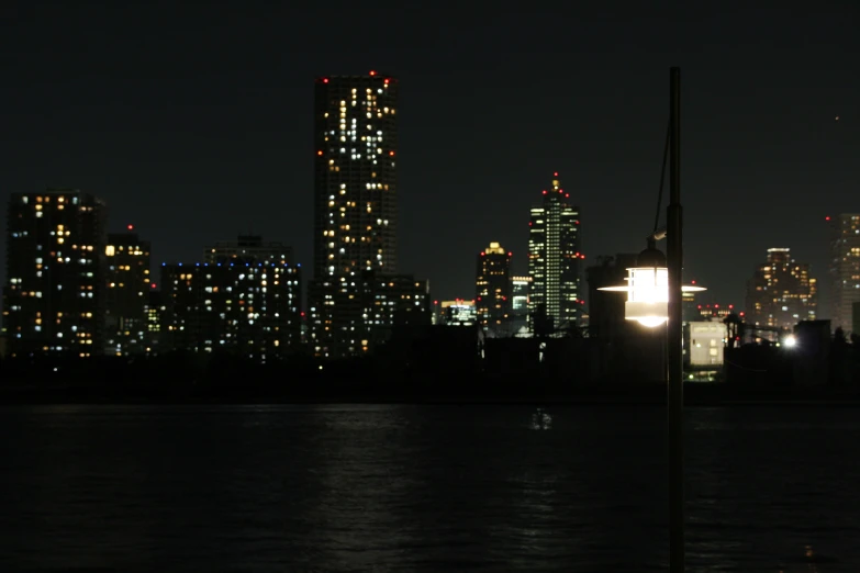 a night view of buildings across the water