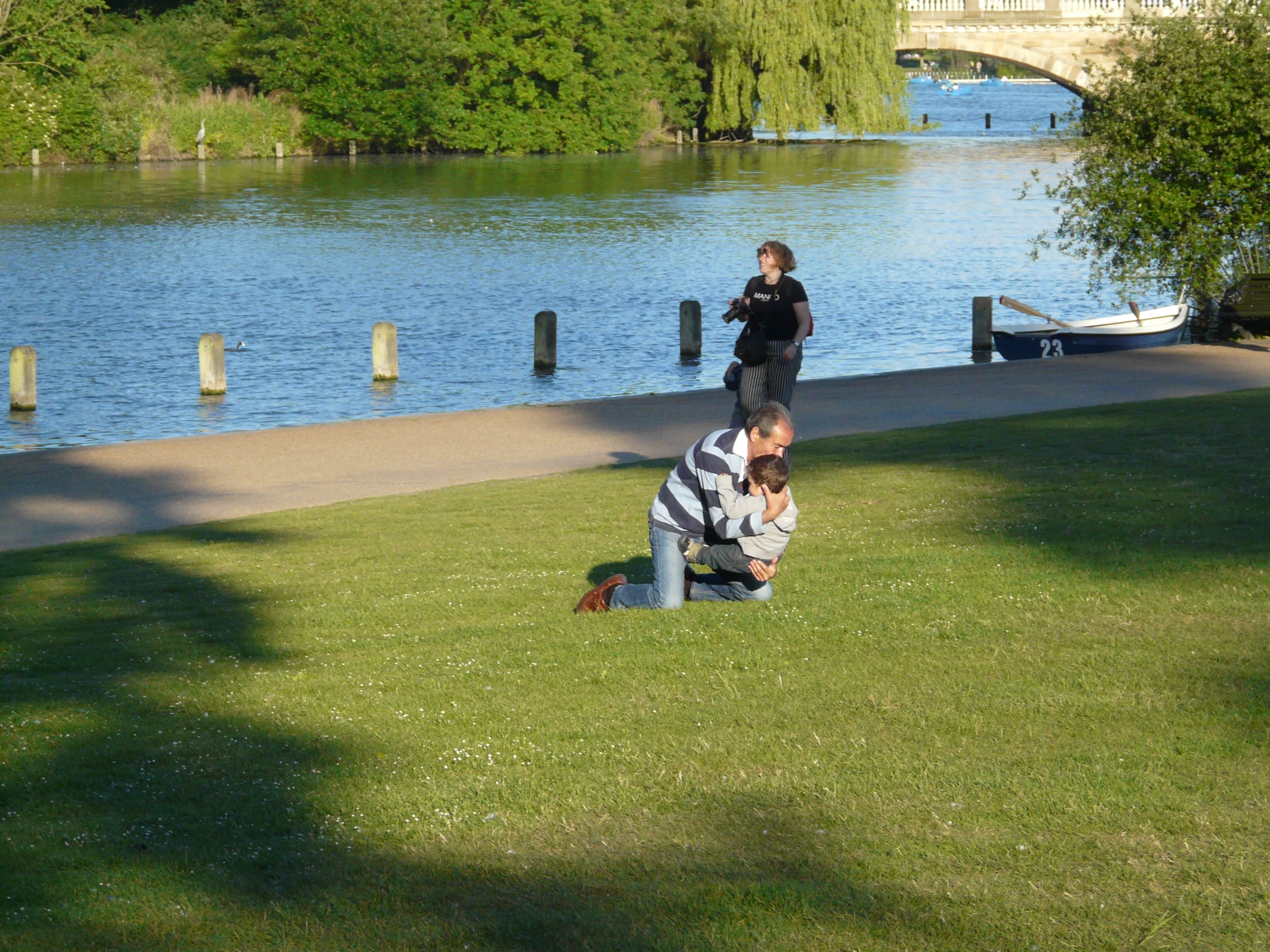 two people that are sitting on the grass