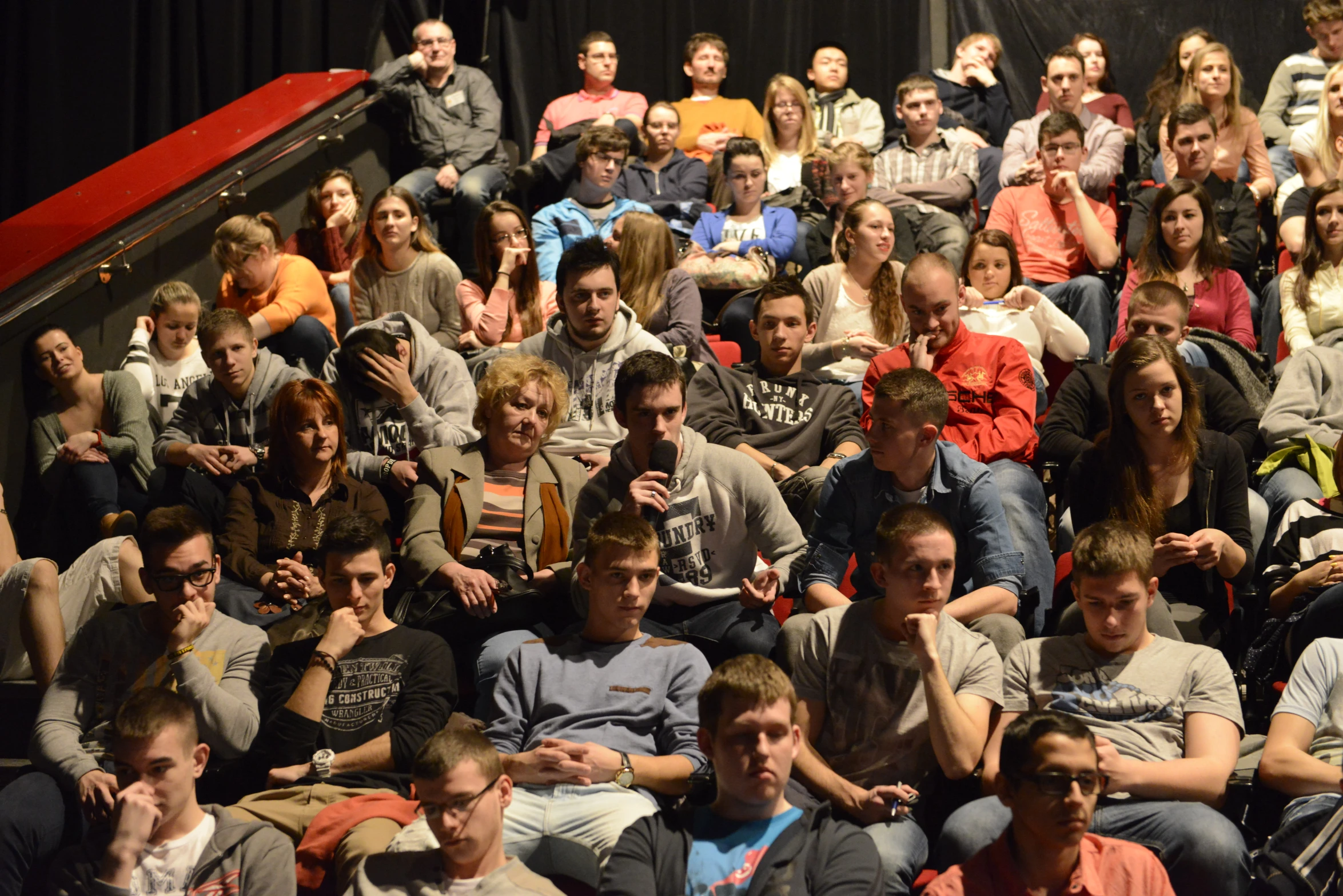 a group of students and parents watch a lecture